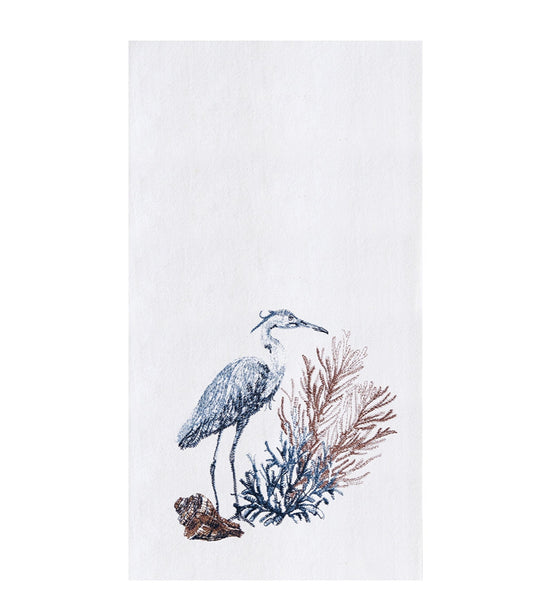 White towel with a blue heron next to blue and brown seagrass and shell.