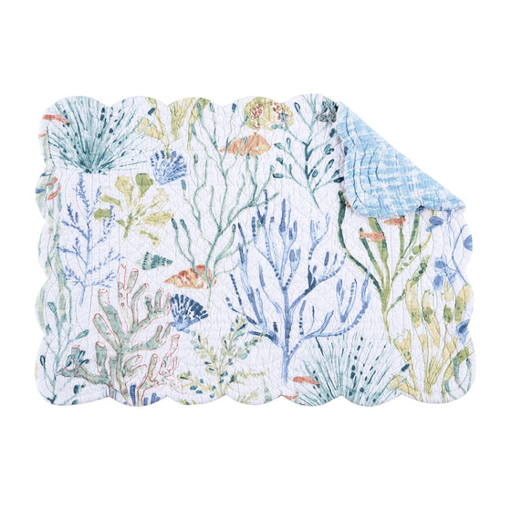 Placemat with pattern of coral, tropical fish, and shells that are light blue and green with hints of red.