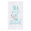 White towel with green-blue text next to a starfish.
