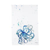 White towel with blue octopus and paint splatters.