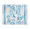 Red, pink, blue, and green placemat with mermaids, fish, and coral between a set of border stripes on the left and right.