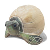 wooden green turtle partially outside of a beige egg