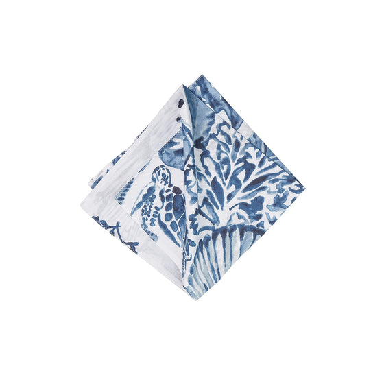Dark blue and white cloth napkin with turtles, shells, and coral
