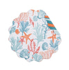 Round placemat with orange, blue, and red coral, starfish, and seashells.