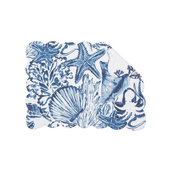 Dark blue and white cloth placemat with sealife, shells, and coral