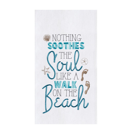 White towel with blue and brown phrase "nothing soothes the soul like a walk on the beach."