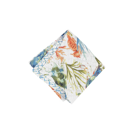 Napkin with orange, blue, and green seahorses, coral, and seagrass.