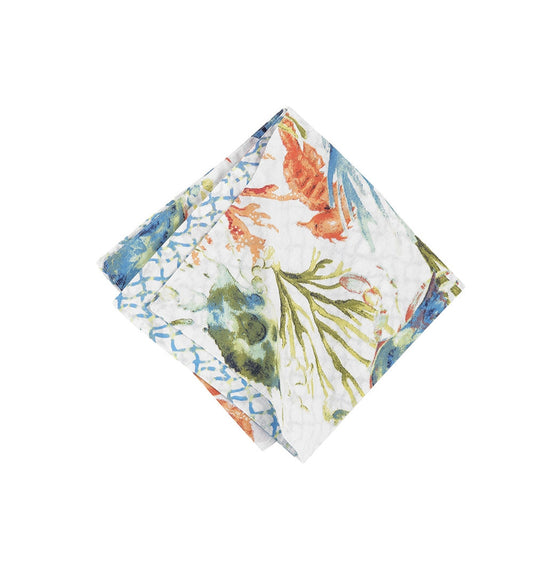 Napkin with orange, blue, and green seahorses, coral, and seagrass.