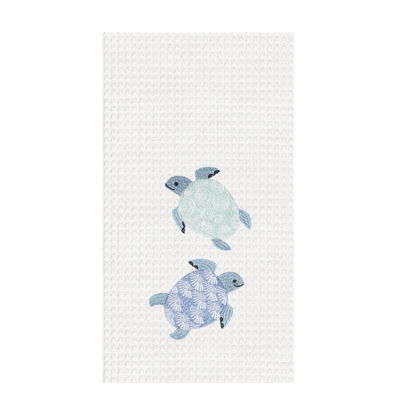 White towel with blue and green turtles.