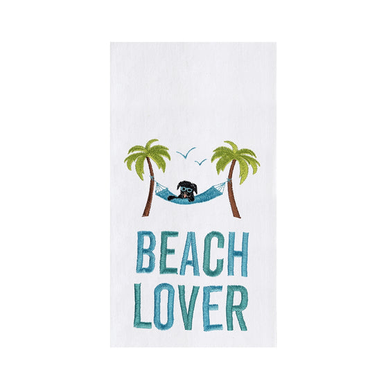 White towel with green-blue lettering of beach lover and an image of a dog in a hammock.