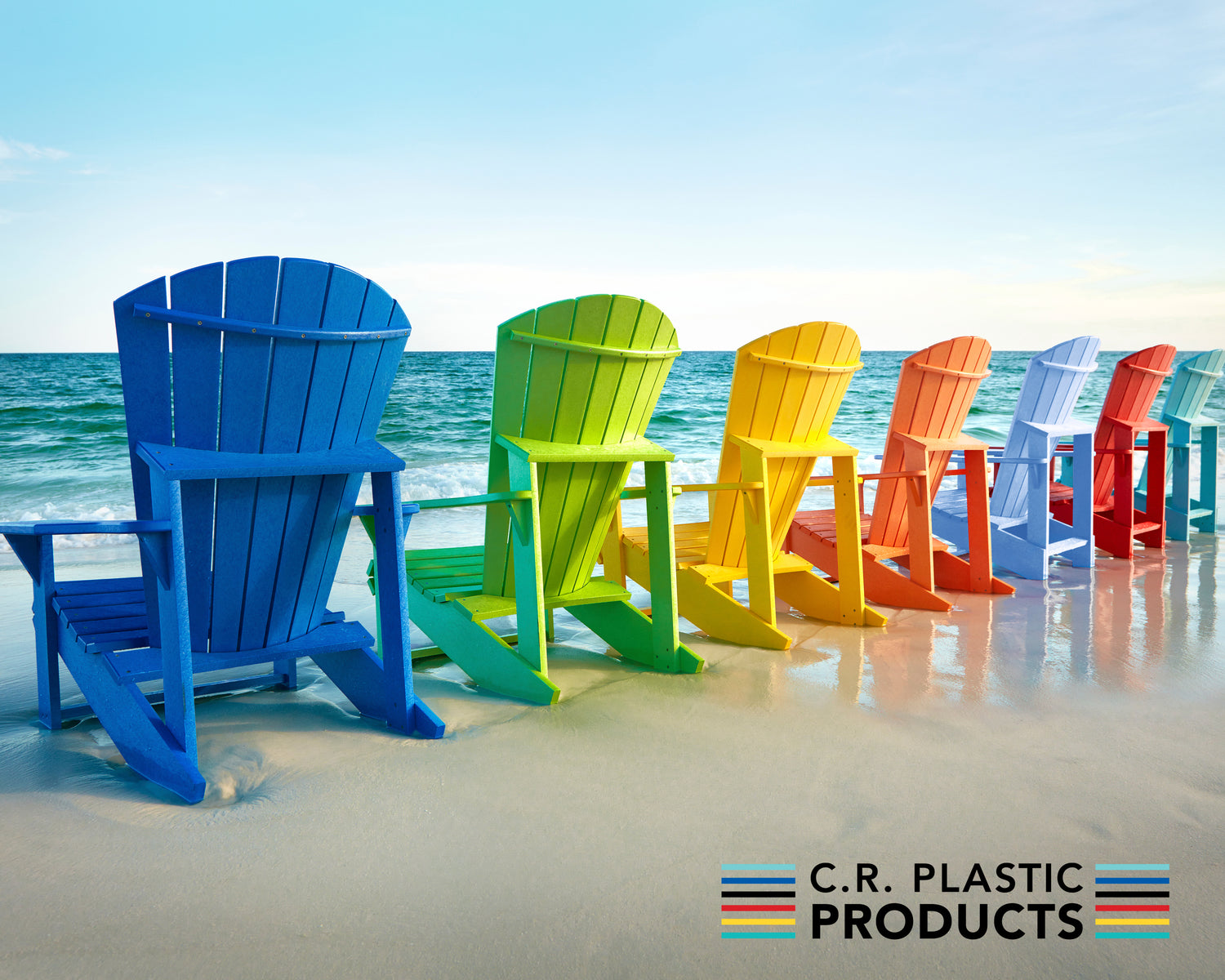 Colorful Adirondack chairs sitting on the beach facing the ocean